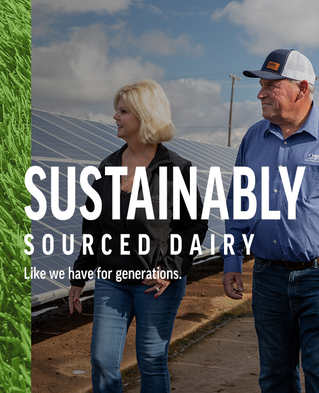 Wind Turbine near farm. Farmer standing near solar panels